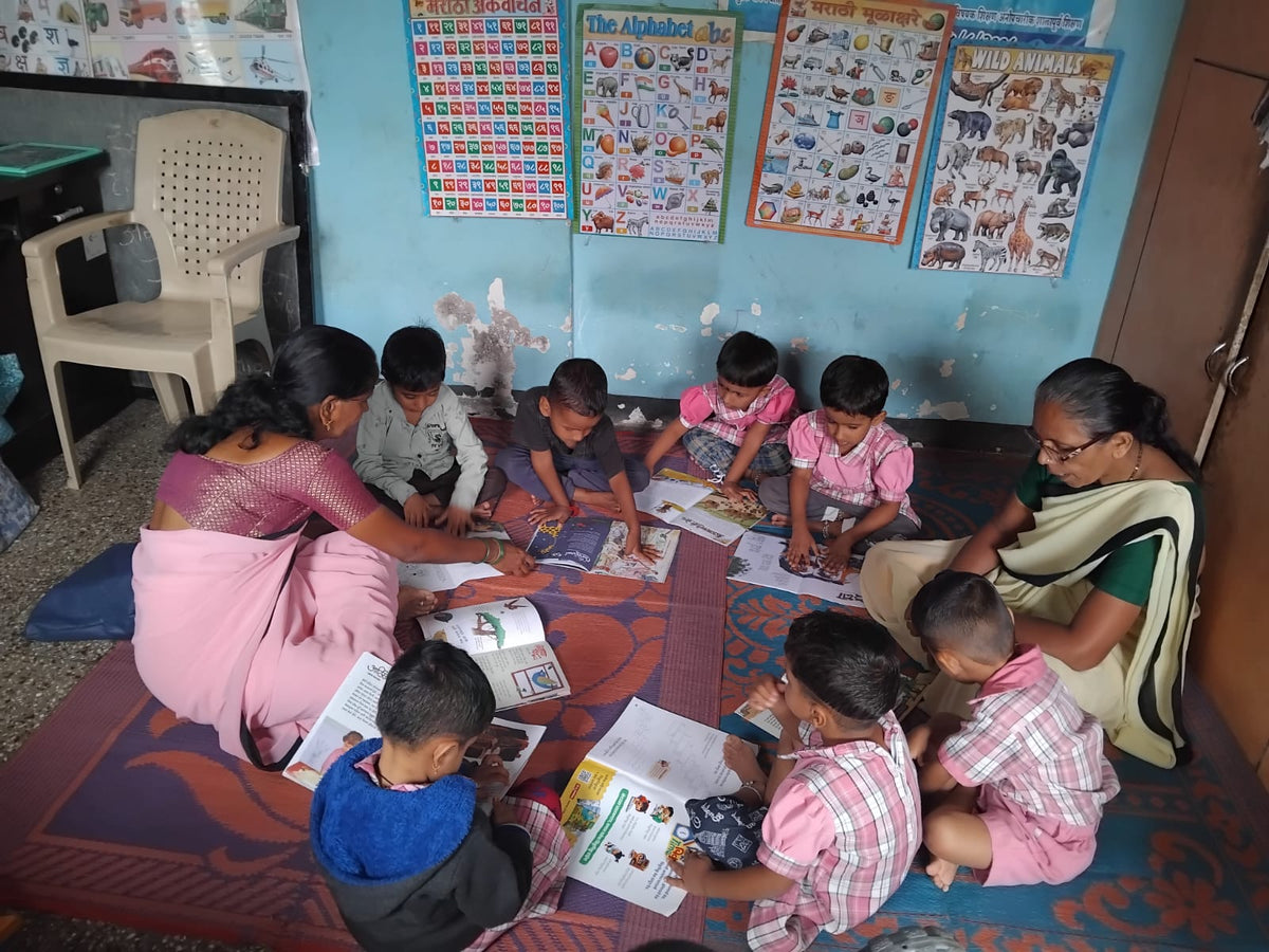 Children reading ChikuPiku books in an Anganwadi